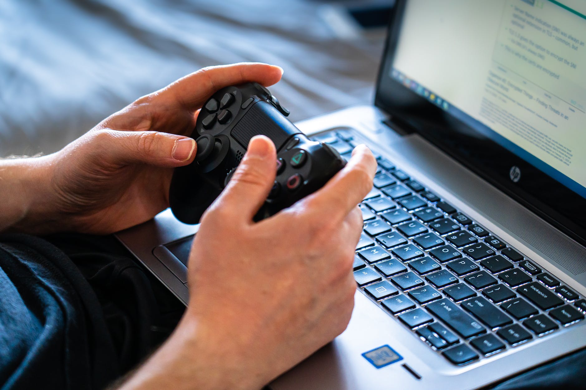 person holding black game controller