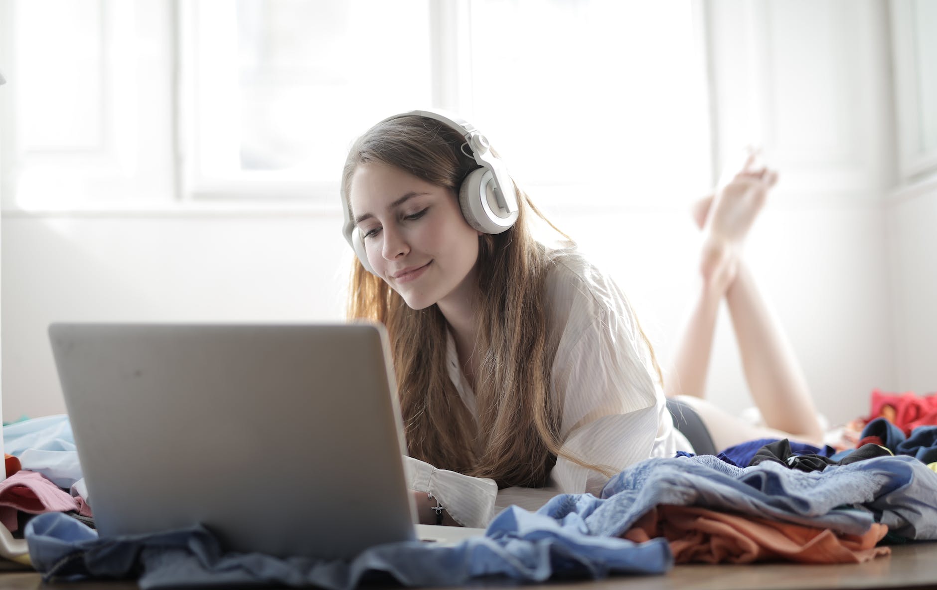 woman in white shirt using silver macbook